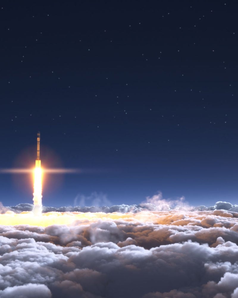 Rocket flies through the clouds on moonlight